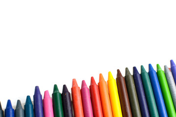 Crayons lined up isolated on white background.