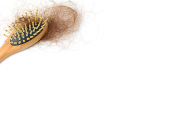 Brown hair loss and comb, hair loss every day, serious problems and hair loss on a white background.
