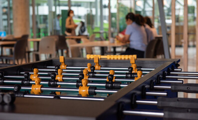 Football table soccer game. Indoor sport game for social relaxing placed in the middle of the canteen in public area.