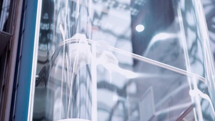 young woman with a smartphone standing in the elevator .