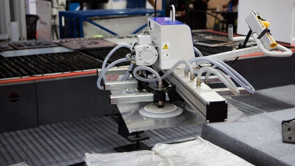 Mechanical vacuum metal sheet lifter loading metal sheet to CNC laser cutting machine. Industrial...