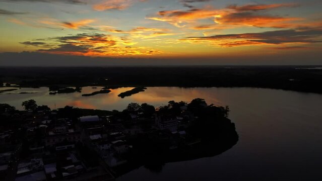  HQ Aerial footage - Drone moving around the town with sunset reflection on the water - Dark scene
