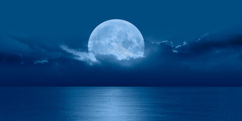Fototapeta na wymiar Night sky with full bright moon in the clouds 