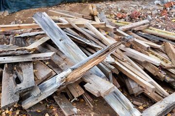 Remains of planks with nails after the installation of concrete formwork. Recycling of lumber....
