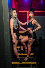 some beautiful girls dancing and posing for a photo at a party. Young people dancing at night club party. selective focus. Long exposition. Moving lights. party concept. Party night club. Nightclub.