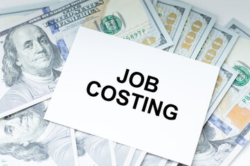 job costing is written on a white business card. Business and advertising concept