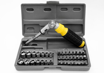 small set of tools in a case with a screwdriver with removable bits and a ratchet wrench