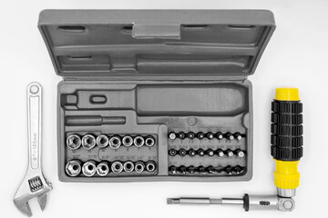 small set of tools in a case with a screwdriver with removable bits and a ratchet wrench