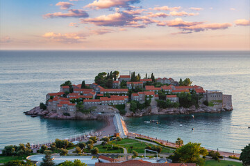Awesome sunset, famous island Sveti Stefan in Adriatic sea at Montenegro, gorgeous summer seascape.