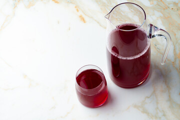Pitcher and glass of compote on table