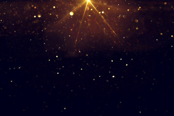 background of abstract glitter lights. gold and black. de focused