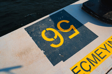 Concrete pier with yellow designations close up