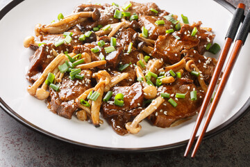 Stir-fried Beef Steak with Asian Mushroom close up on the plate. Horizontal