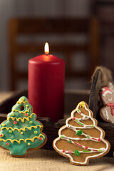 christmas food background with a burning candle and gingerbread