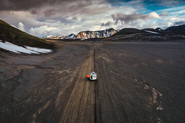 Road trip with tourist 4x4 vehicle car parked on volcanic desert with crater on dirt road in Landmannalaugar at Icelandic Highlands © Mumemories