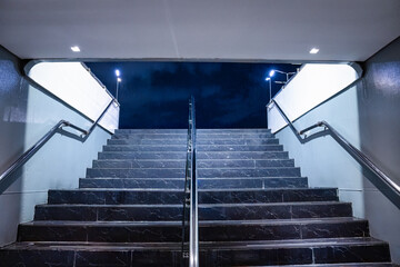Modern frame entrance with granite stair with handrail going up to the stage with lighting and...