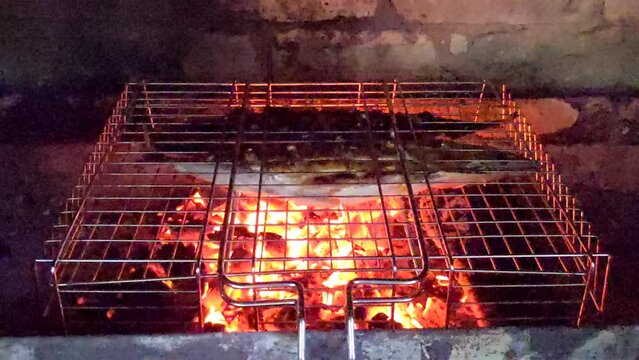 Outdoor kitchen for Barbeque Grill. Outdoor brick BBQ grill and baking oven. Fire flames and sparks of bonfire. Organic natural food cooked outdoor