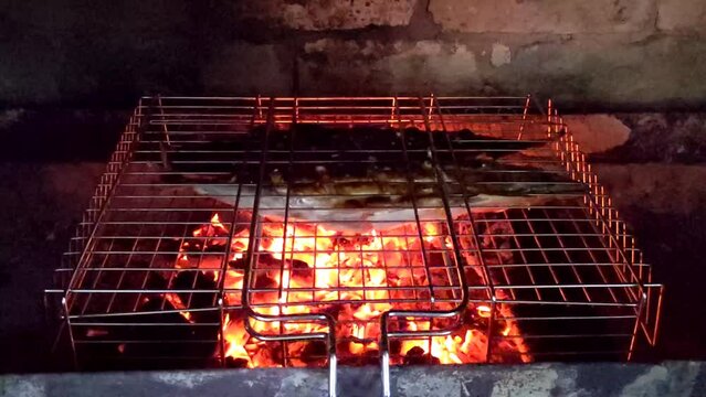 Outdoor kitchen for Barbeque Grill. Outdoor brick BBQ grill and baking oven. Fire flames and sparks of bonfire. Organic natural food cooked outdoor