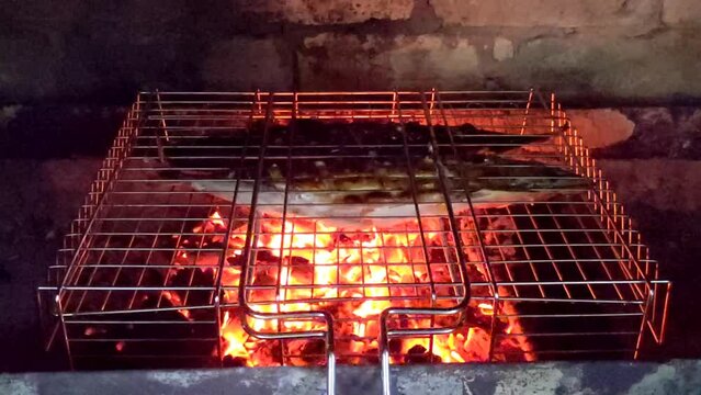 The fire is in a summer brick oven for barbecue, grill and other outdoor dishes