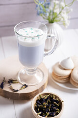 Thai blue tea Anchan with whipped vegetable milk on a light background. Healthy drink
