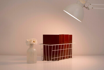 Working evening space with books, decor, table lamp and copy space on white table