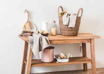 Laundry room. Laundry basket, cleaning accessories on a wooden bench. Scandinavian style interior