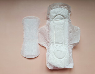 Set of various sanitary napkins on pink background