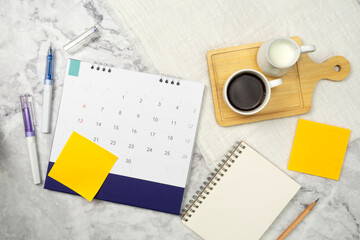 Calendar with note paper and coffee on marble texture background. Plan notepad list concept. Notebook for Planner plan timetable.