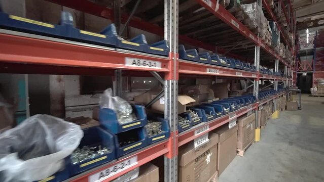 large factory warehouse. store aisles. The camera moves from left to right. Delivery to the warehouse. Logistics business, moving boxes and goods. freight mail