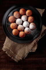 Balls of freshly baked homemade cottage cheese doughnuts.