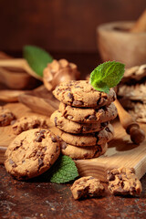 Chocolate cookies with mint on a brown background.