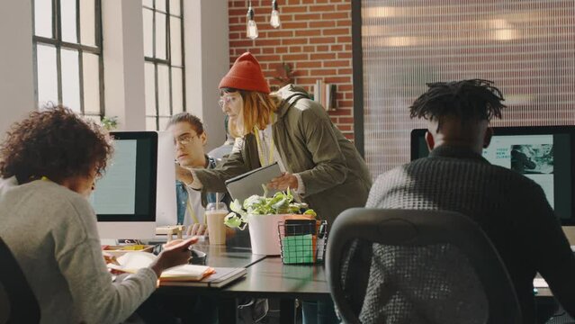 Collaboration, creative and team working on a web design project together in a coworking space office. Diversity, teamwork and developers planning a website development strategy in a modern workplace