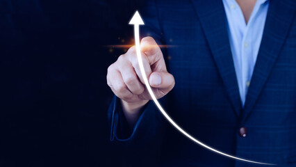 Businessman pointing touching growth on up arrow chart icon, hands touch the up arrow that...