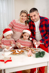 Children prepares holiday food for family. Children chef. Family preparation holiday food. Mother, father and sons cooking Christmas cookies. Kids cooking Christmas cookies. Kids baking cookies
