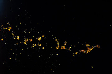 Orange, lemon juice or oil lubricant splash, liquid gold yellow drink drops. Fruit beverage water elements in line form . Fresh splashing and flowing jets, black background isolated freeze motion