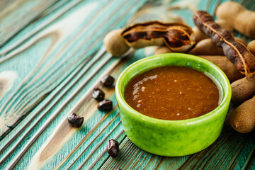 sweet and sour tamarind sauce on a rustic wooden background