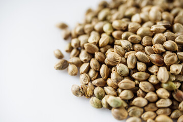 natural hemp seeds on a white acrylic background