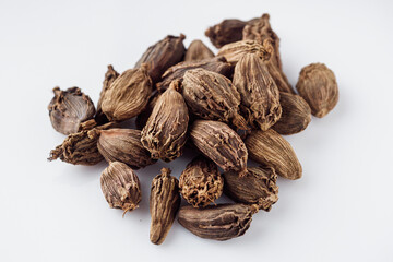 barrel dried black cardamom on a white background
