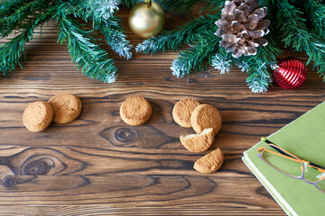 New Year's Eve background with cookies, book and glasses. Concept - nice cozy evenings with your favorite book.