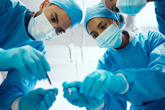 Surgery, Teamwork Or Doctors In A Medical Emergency Operation Theater With Collaboration Or Team Work Helping A Patient. Support, Life Insurance Or Focused Healthcare Workers In Face Masks Working