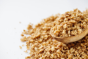 fresh raw buckwheat flakes on a white background