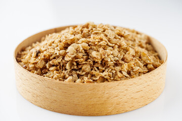 fresh raw buckwheat flakes on a white background