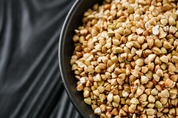 organic raw green buckwheat on a black background