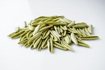 raw green cavatelli pasta on a white background