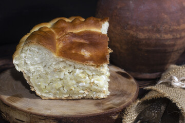 Russian type of pirog stuffed with rice,  hard-boiled egg. Homemade pie stuffed with egg and rice - obrazy, fototapety, plakaty