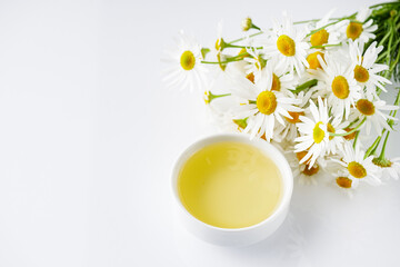 Obraz na płótnie Canvas aromatic chamomile essential oil on a white background