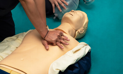 CPR training medical procedure workshop. Demonstrating chest compressions.