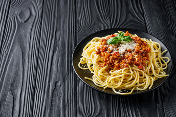 delicious Bolognese pasta on a black plate