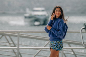 young girl talking on mobile phone in the port