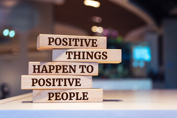Wooden blocks with words 'Positive Things Happen to Positive People'.